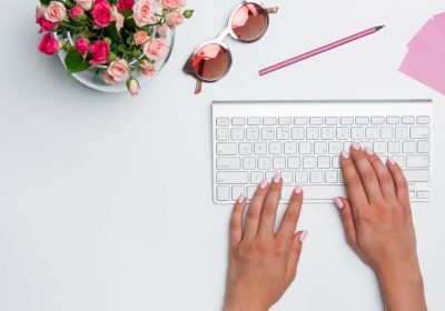 office-desk-table-with-female-hands-computer-suppl-PBNTWZ2.jpg